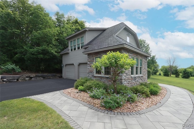 view of side of property with a garage and a lawn