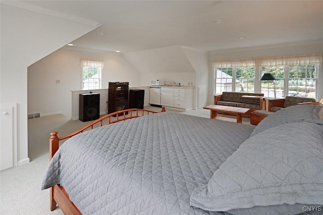 bedroom with ornamental molding, lofted ceiling, sink, and light carpet