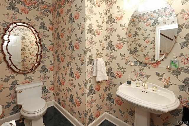 bathroom with tile patterned flooring, sink, and toilet