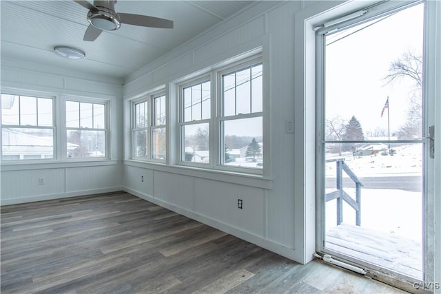 unfurnished sunroom with ceiling fan