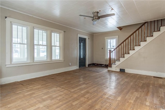 foyer featuring light hardwood / wood-style flooring, ornamental molding, and ceiling fan