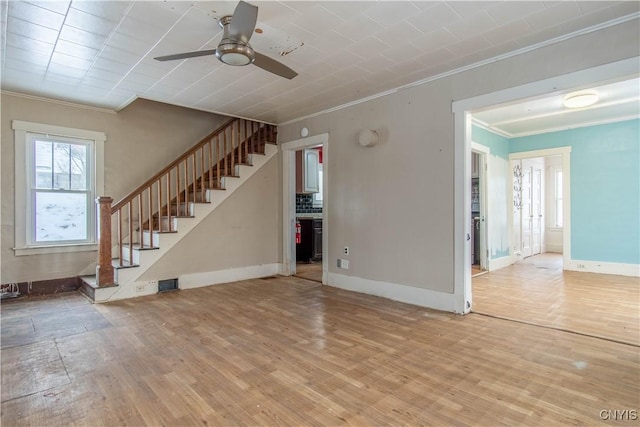 unfurnished living room featuring ornamental molding, ceiling fan, and light hardwood / wood-style flooring