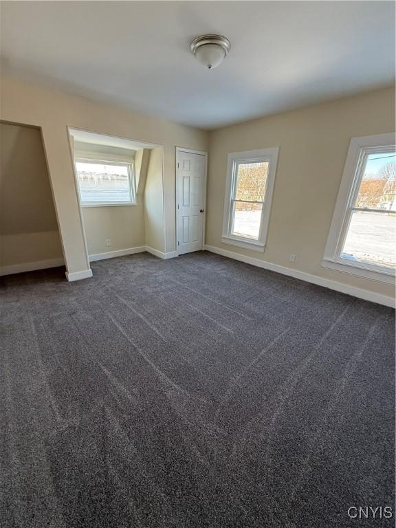 bonus room with dark colored carpet