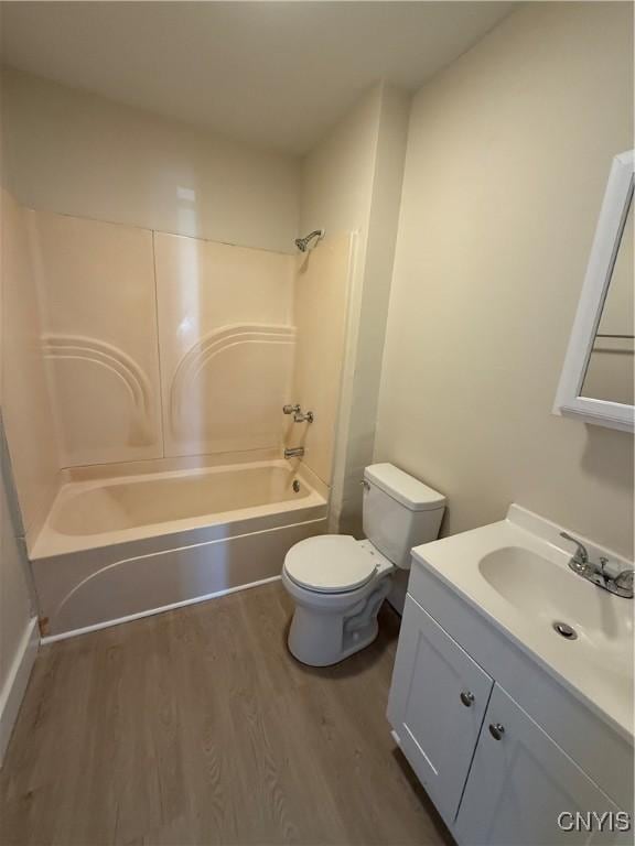 full bathroom featuring vanity, toilet, hardwood / wood-style floors, and shower / bathing tub combination