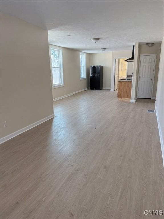 unfurnished living room featuring hardwood / wood-style flooring