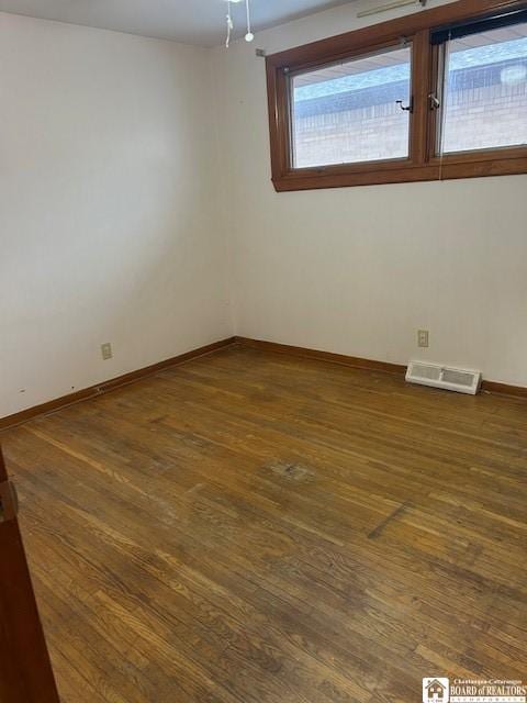 unfurnished room with dark hardwood / wood-style flooring