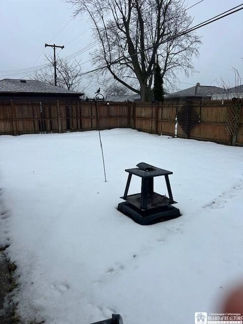 view of yard layered in snow