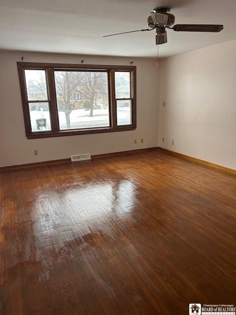 empty room with hardwood / wood-style flooring and ceiling fan