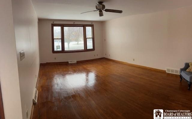 spare room with dark hardwood / wood-style flooring and ceiling fan