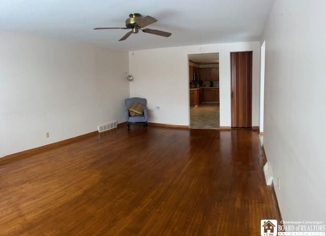 unfurnished room with dark hardwood / wood-style floors and ceiling fan