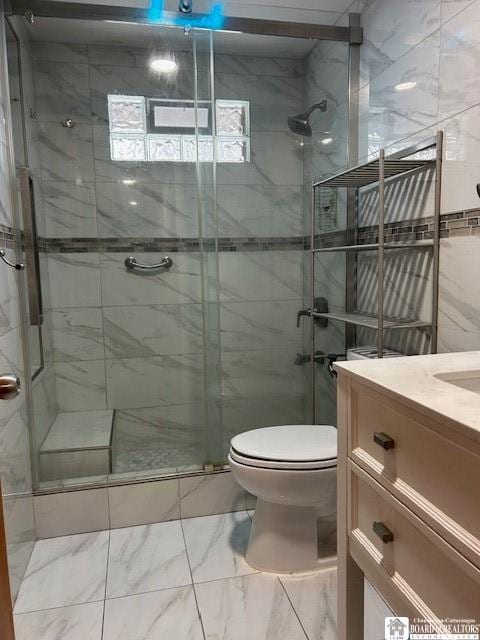 bathroom featuring vanity, toilet, and an enclosed shower