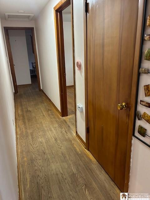 corridor with light hardwood / wood-style flooring