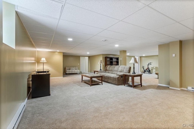 carpeted living room with a paneled ceiling and baseboard heating