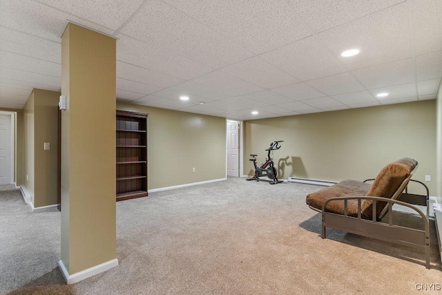 living area with light colored carpet and a baseboard heating unit