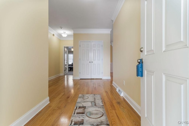 corridor with crown molding and light wood-type flooring