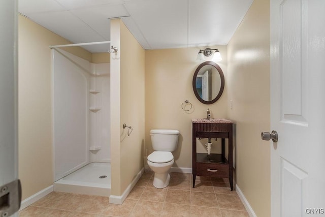 bathroom featuring toilet, tile patterned floors, and walk in shower