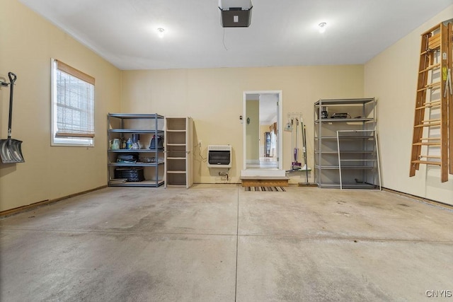 garage featuring heating unit and a garage door opener