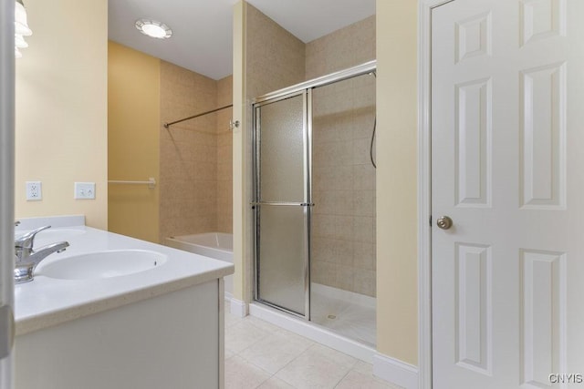 bathroom featuring tile patterned flooring, vanity, and a shower with door