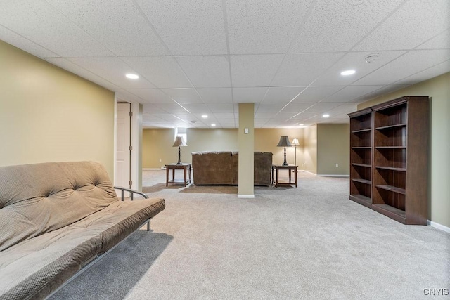 carpeted living room with a drop ceiling