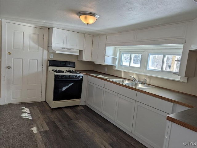 kitchen featuring white range with gas cooktop, sink, and white cabinets