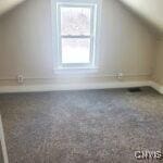 additional living space featuring lofted ceiling