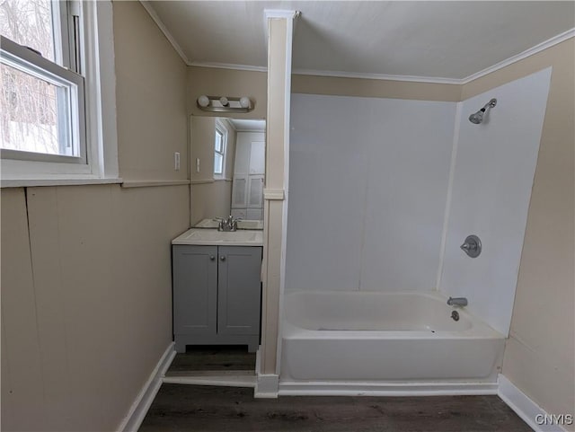 bathroom featuring hardwood / wood-style flooring, vanity, crown molding, and shower / tub combination