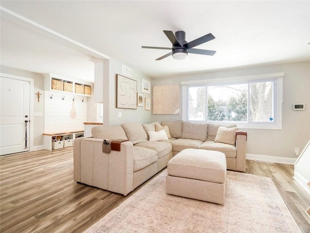 living room with ceiling fan and light hardwood / wood-style flooring