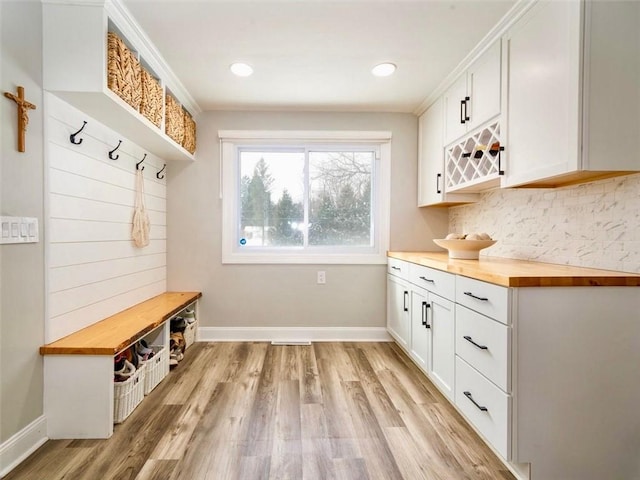 mudroom featuring crown molding and light hardwood / wood-style floors