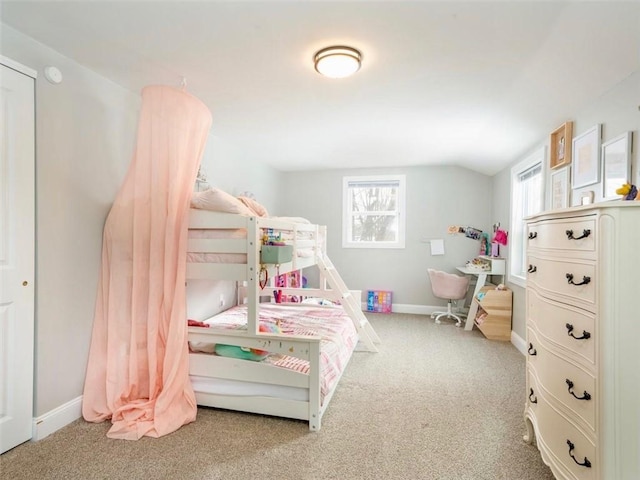 carpeted bedroom featuring lofted ceiling