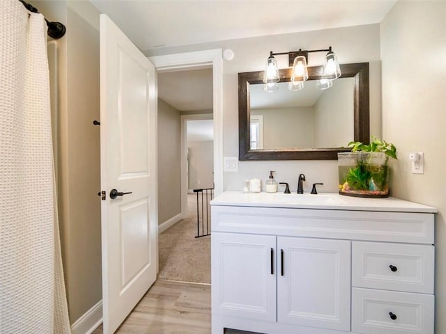 bathroom featuring hardwood / wood-style flooring, vanity, and a shower with curtain