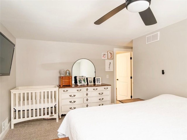 bedroom with ceiling fan and light carpet