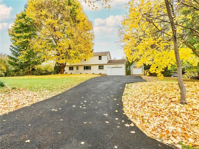 view of front of home featuring a garage and a front lawn