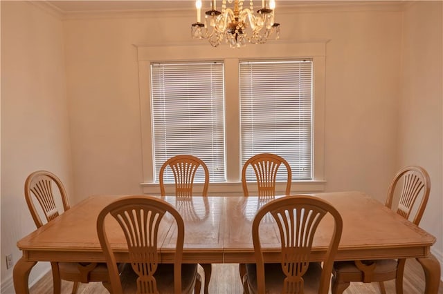 dining space featuring crown molding and a notable chandelier