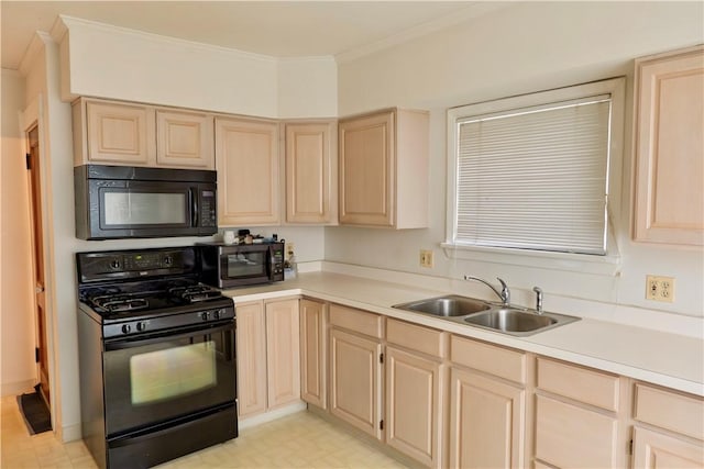 kitchen featuring sink, light brown cabinets, and black appliances