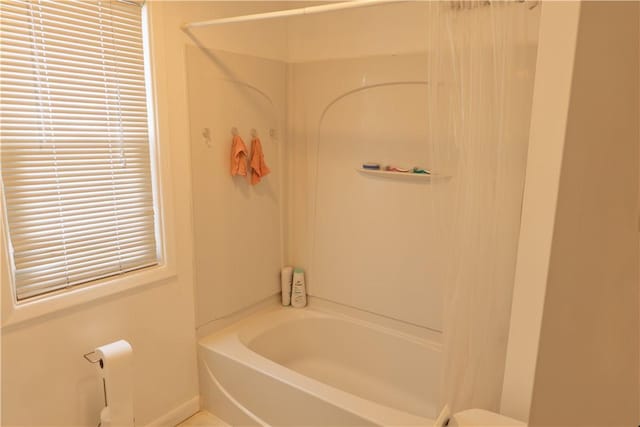 bathroom with shower / bath combo with shower curtain