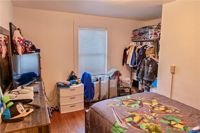 bedroom with hardwood / wood-style floors and a closet