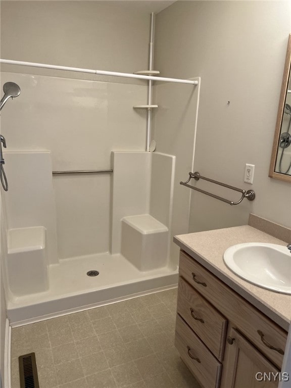 bathroom featuring vanity and a shower