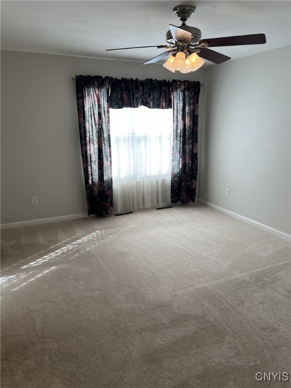 spare room featuring ceiling fan and carpet flooring