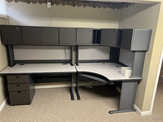 home office featuring light colored carpet and built in desk