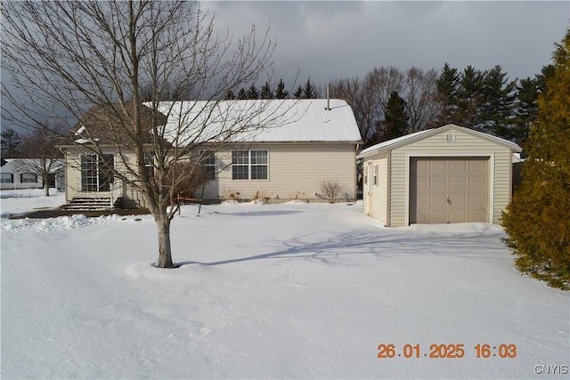 view of front of property with a garage and an outdoor structure