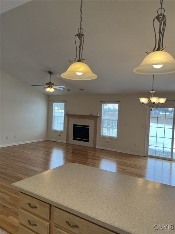 kitchen featuring hanging light fixtures, light brown cabinetry, and ceiling fan