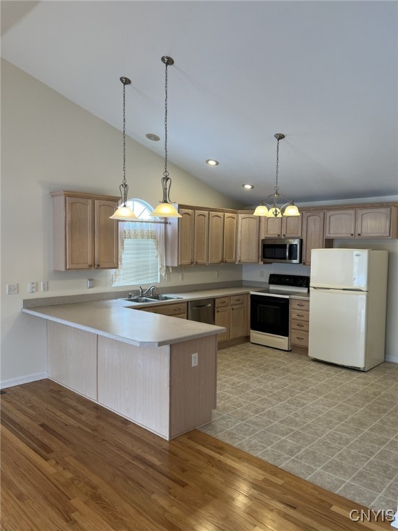 kitchen featuring hanging light fixtures, appliances with stainless steel finishes, and kitchen peninsula