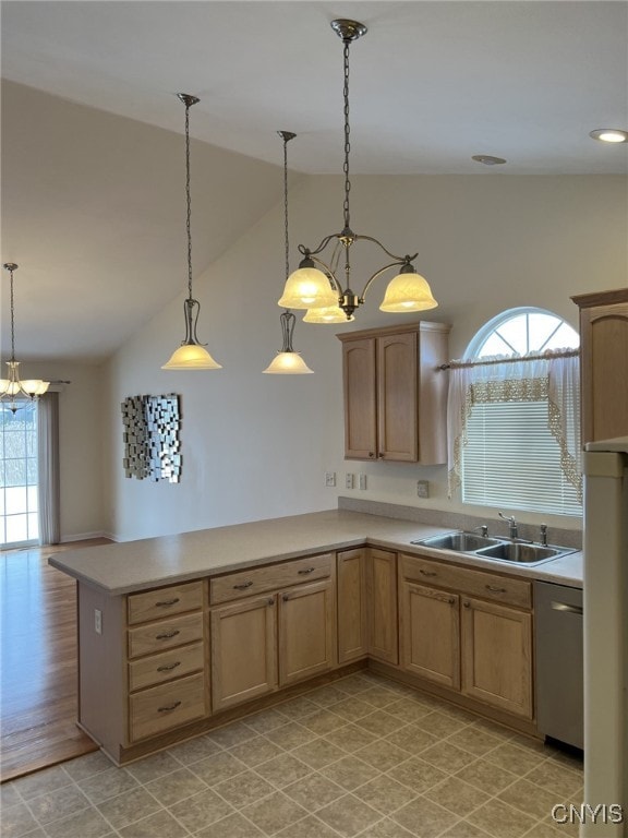 kitchen featuring lofted ceiling, decorative light fixtures, dishwasher, and sink