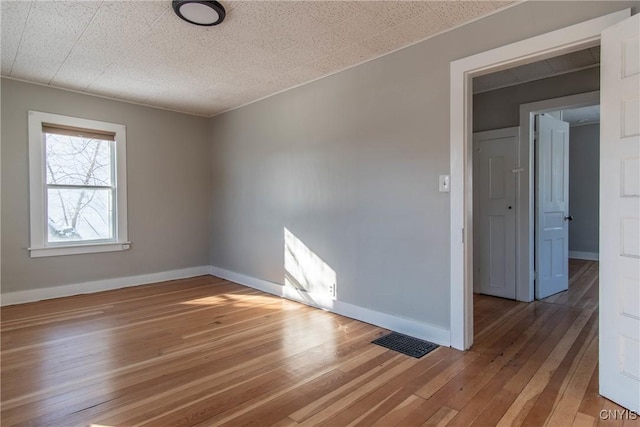 unfurnished room with hardwood / wood-style floors