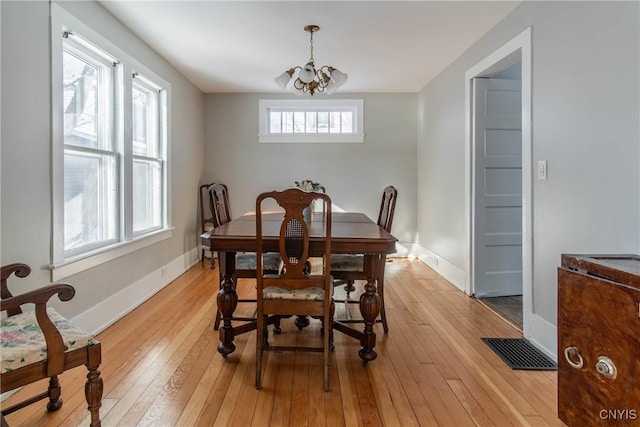 dining area with an inviting chandelier, light hardwood / wood-style flooring, and a healthy amount of sunlight