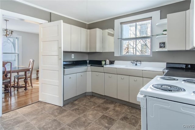 kitchen featuring ornamental molding, white electric range, and white cabinets