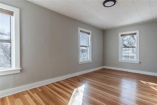 spare room with hardwood / wood-style flooring