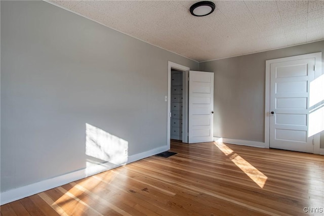 empty room featuring hardwood / wood-style floors