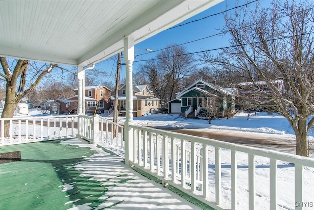 view of snow covered back of property