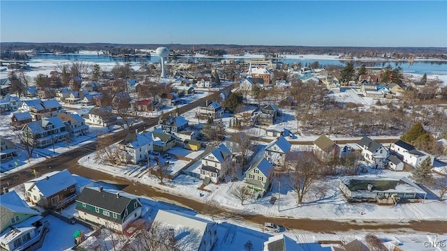 snowy aerial view featuring a water view